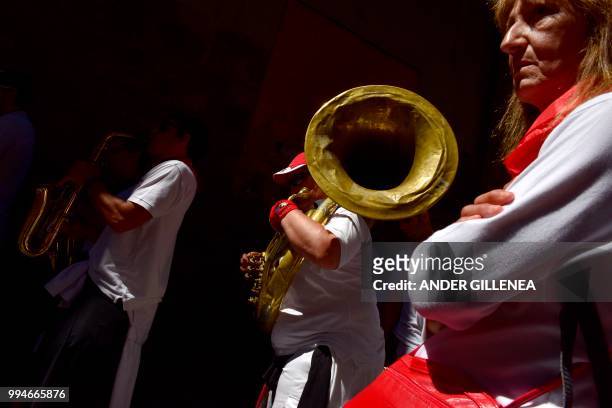Revelers play music on the street during the San Fermin bull run festival in Pamplona, northern Spain on July 9, 2018 - Each day at 8am hundreds of...