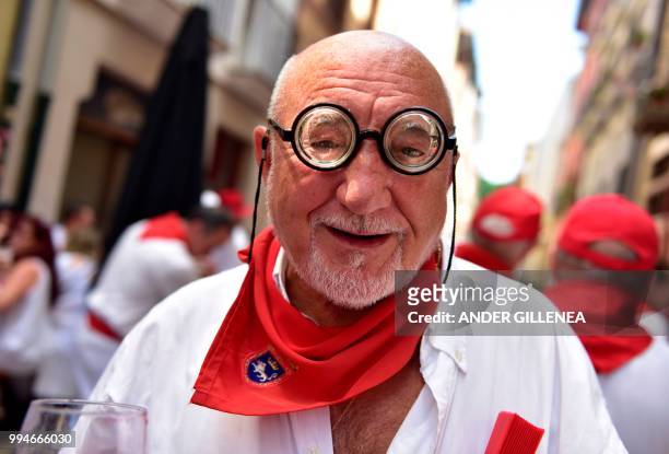 Reveler takes part in the San Fermin bull run festival in Pamplona, northern Spain on July 9, 2018 - Each day at 8am hundreds of people race with six...