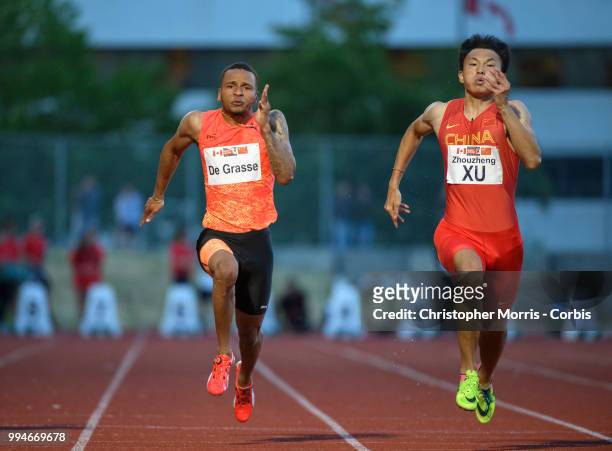 Andre De Grasse , and China's Xu Zhouzheng compete in the men's 100 meters at Percy Perry Stadium on June 26, 2018 in Burnaby, Canada.