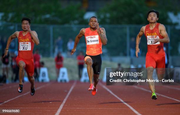 Xu Haiyang of China , Andre De Grasse , and Xu Zhouzheng of China compete in the men's 100 meters at Percy Perry Stadium on June 26, 2018 in Burnaby,...