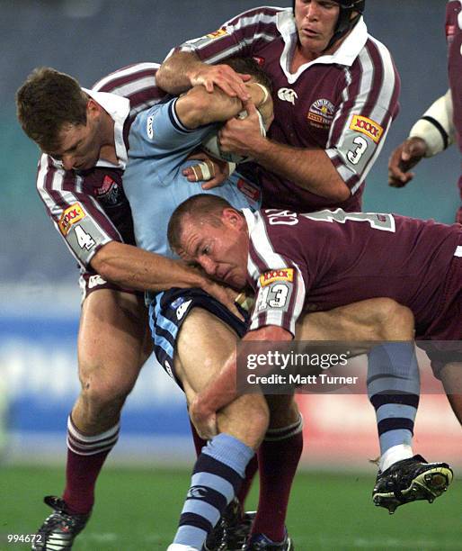 Paul Bowman Darren Smith and Kevin Campion of QLD Maroons tackle Bryan Fletcher of the NSW Blues during the second State of Origin match played at...