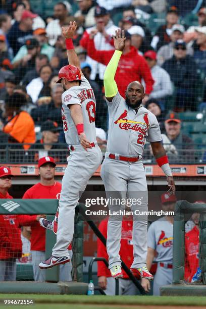 Matt Carpenter of the St Louis Cardinals celebrates with teammate Marcell Ozuna after hitting a solo home run in the second inning against the San...