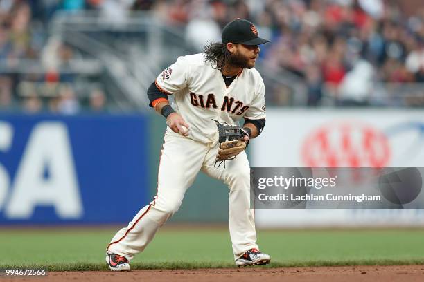 Brandon Crawford of the San Francisco Giants fields the ball at shortstop in the third inning against the St Louis Cardinals at AT&T Park on July 5,...