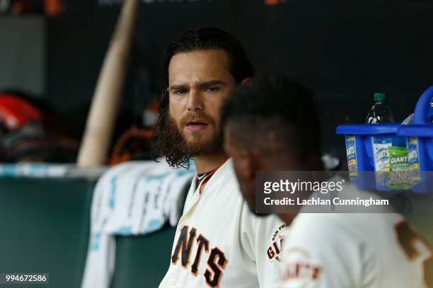 Brandon Crawford talks to teammate Andrew McCutchen of the San Francisco Giants in the dugout during the third inning against the St Louis Cardinals...