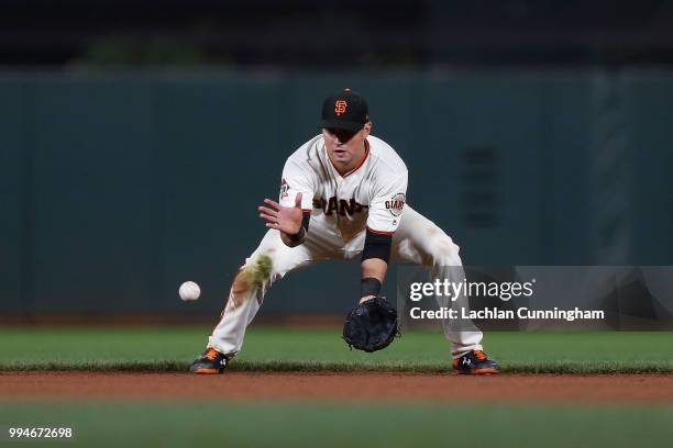 Joe Panik of the San Francisco Giants fields the ball in the ninth inning against the St Louis Cardinals at AT&T Park on July 5, 2018 in San...