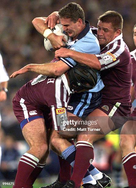 Darren Smith and Shane Webcke of QLD Maroons tackle Mark Hughes of the NSW Blues during the second State of Origin match played at Stadium Australia,...