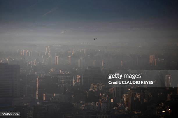 View of smog over Santiago, on July 9, 2018. - Chilean authorities declared a new environmental preemergency Monday, as high levels of air pollution...