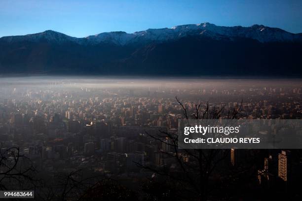 View of smog over Santiago, on July 9, 2018. - Chilean authorities declared a new environmental preemergency Monday, as high levels of air pollution...