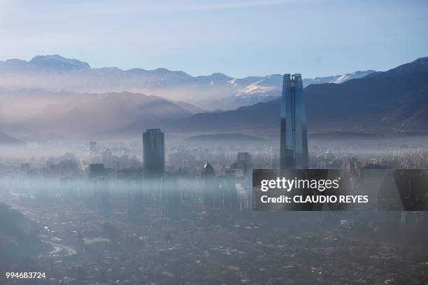 View of smog over Santiago, on July 9, 2018. - Chilean authorities declared a new environmental preemergency Monday, as high levels of air pollution...