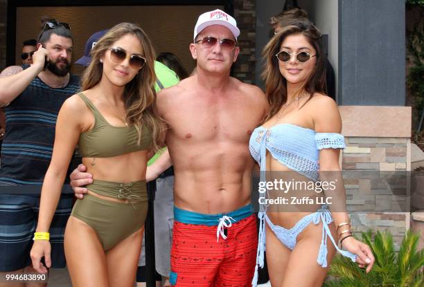 Octagon Girls Brittney Palmer and Arianny Celeste pose for a photo with a fan during a UFC Pool Party on July 8, 2018 at the Hard Rock Hotel & Casino...