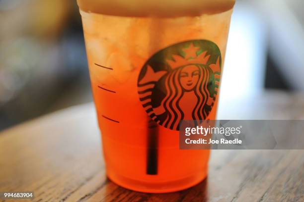 Plastic straw is seen in a Starbucks drink on July 9, 2018 in Miami, Florida. Starbucks announced today that it plans on phasing out all plastic...