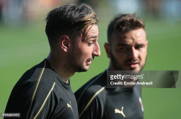 Gianluigi Donnarumma of AC Milan speaks with his teammate Gabriel during the AC Milan training session at the club's training ground Milanello on...