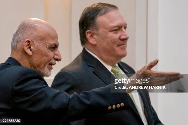 Afghan President Ashraf Ghani and US Secretary of State Mike Pompeo arrive for a news conference at the Presidential Palace in Kabul, Afghanistan,...