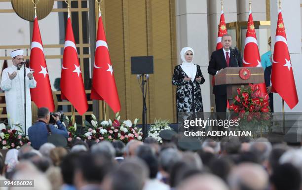 Turkish President Tayyip Erdogan , next to his wife Emine Erdogan, prays during a ceremony at the Presidential Palace in Ankara, on July 9, 2018.