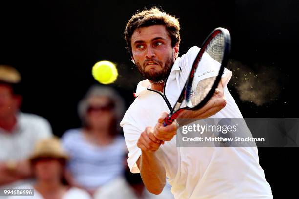 Gilles Simon of France plays a backhand against Juan Martin Del Potro of Argentina during their Men's Singles fourth round match on day seven of the...