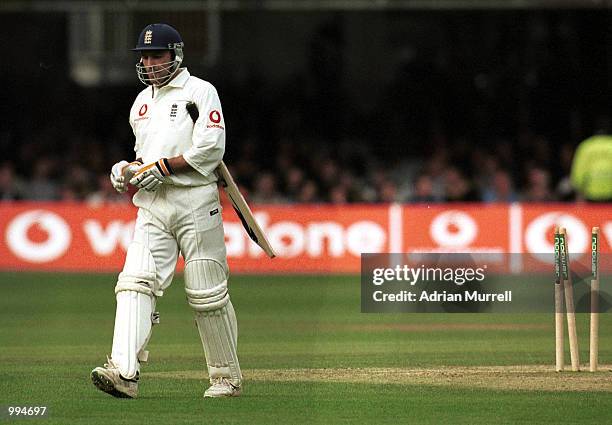 Mark Ramprakash of England walks back to the pavilion after being clean bowled by Brett Lee of Australia during the match between England and...