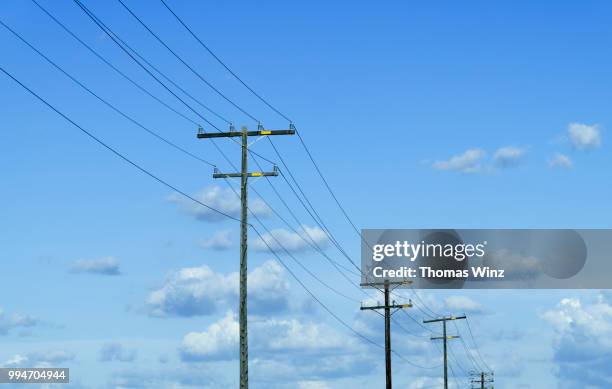 power lines and cloud - telephone pole stock pictures, royalty-free photos & images
