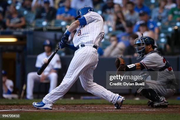 Manny Pina of the Milwaukee Brewers hits a single in the third inning against the Atlanta Braves at Miller Park on July 6, 2018 in Milwaukee,...