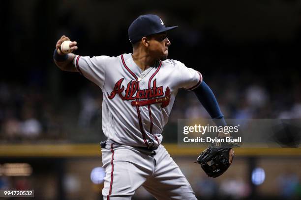 Johan Camargo of the Atlanta Braves throws to first base in the eighth inning against the Milwaukee Brewers at Miller Park on July 6, 2018 in...