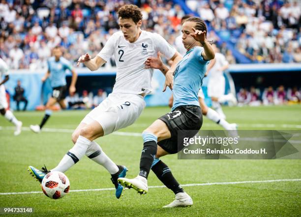 Benjamin Pavard of France and Diego Laxalt of Uruguay battle for the ball during the 2018 FIFA World Cup Russia Quarter Final match between Winner...