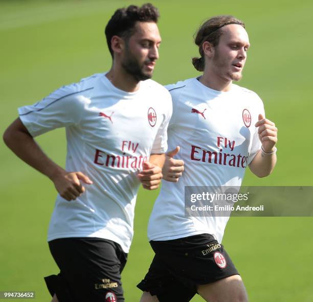 Alen Halilovic of AC Milan trains with his teammate Hakan Calhanoglu during the AC Milan training session at the club's training ground Milanello on...