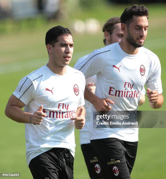 Jose Mauri of AC Milan trains with his teammate Hakan Calhanoglu during the AC Milan training session at the club's training ground Milanello on July...