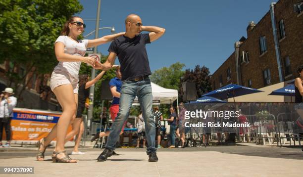 Victoria Bilyk and Ciro Viviano, both of Nudiczo Dance Studio, show off their moves on St. Clair Avenue, part of Salsa on St. Clair festival. Summer...