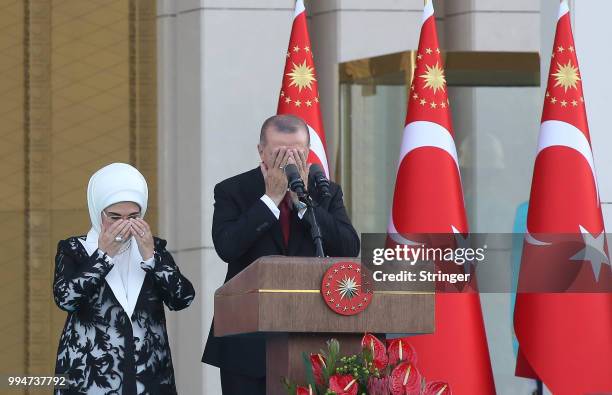 Turkey's President Tayyip Erdogan, accompanied by his wife Emine Erdogan, prays during a ceremony at the Presidential Palace on July 9, 2018 in...