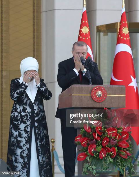 Turkey's President Tayyip Erdogan, accompanied by his wife Emine Erdogan, prays during a ceremony at the Presidential Palace on July 9, 2018 in...