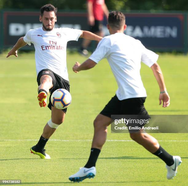 Hakan Calhanoglu of AC Milan controls the ball during the AC Milan training session at the club's training ground Milanello on July 9, 2018 in...