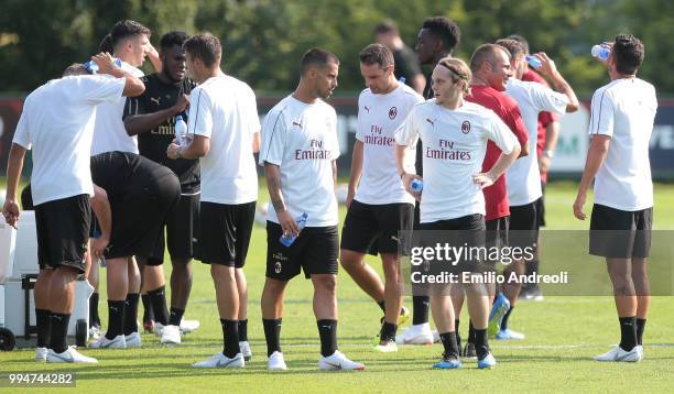 Fernandez Suso of AC Milan speaks with his teammate Alen Halilovic during the AC Milan training session at the club's training ground Milanello on...