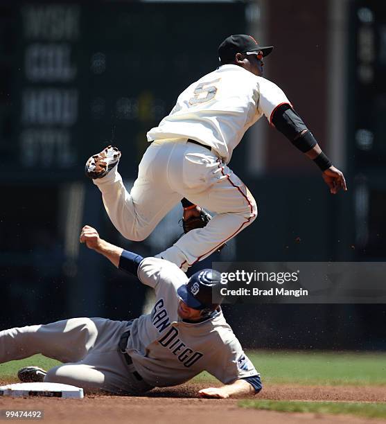 Juan Uribe of the San Francisco Giants turns a double play, forcing out San Diego Padres base runner Chase Headley at second base during the game...