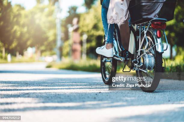 young woman with bike - three wheeled vehicle stock pictures, royalty-free photos & images