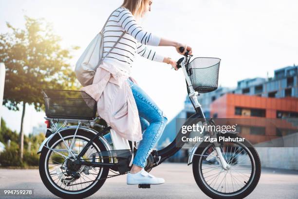 beautiful young woman riding a bike on a sunny day - three wheeled vehicle stock pictures, royalty-free photos & images