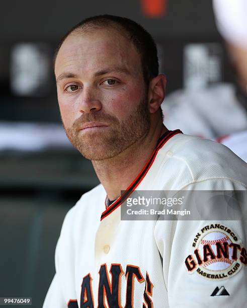 Nate Schierholtz of the San Francisco Giants watches from the dugout during the game between the San Diego Padres and the San Francisco Giants on...
