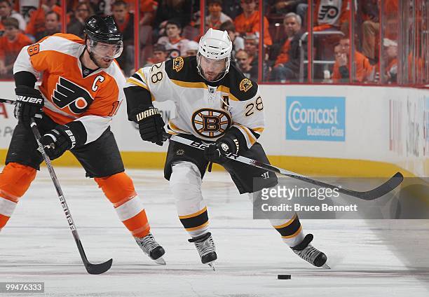 Mark Recchi of the Boston Bruins skates against Mike Richards of the Philadelphia Flyers in Game Six of the Eastern Conference Semifinals during the...