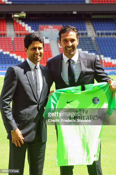President of PSG Nasser Al-Khelaifi presents to Gianluiggi Buffon his new jersey during the Italian official presentation after signing for PSG at...