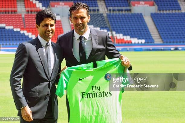 President of PSG Nasser Al-Khelaifi presents to Gianluiggi Buffon his new jersey during the Italian official presentation after signing for PSG at...