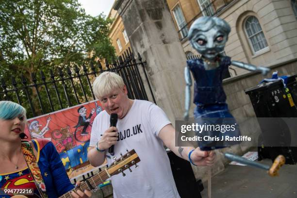 Boris Johnson impersonator sings protest songs opposite Downing Street on July 9, 2018 in London, England. Boris Johnson resigned earlier today as...