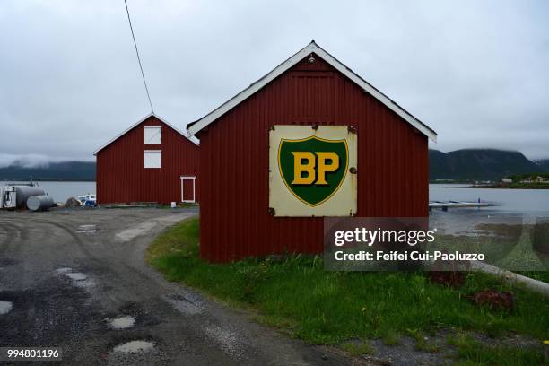 boathouse with bp logo on the wall at risøyhamn, andøya island, norway - log cabin logo stock pictures, royalty-free photos & images