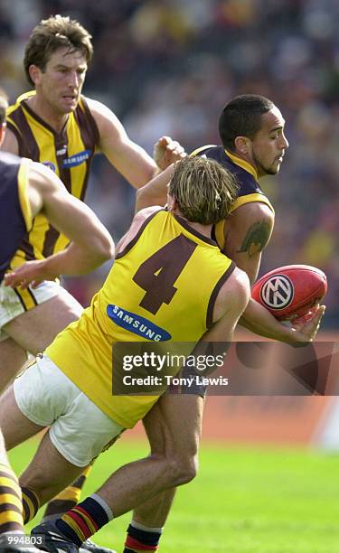 Andrew McLeod for Adelaide handballs under pressure from Rayden Tallis for Hawthorn Adelaide marks in the match between the Adelaide Crows and the...