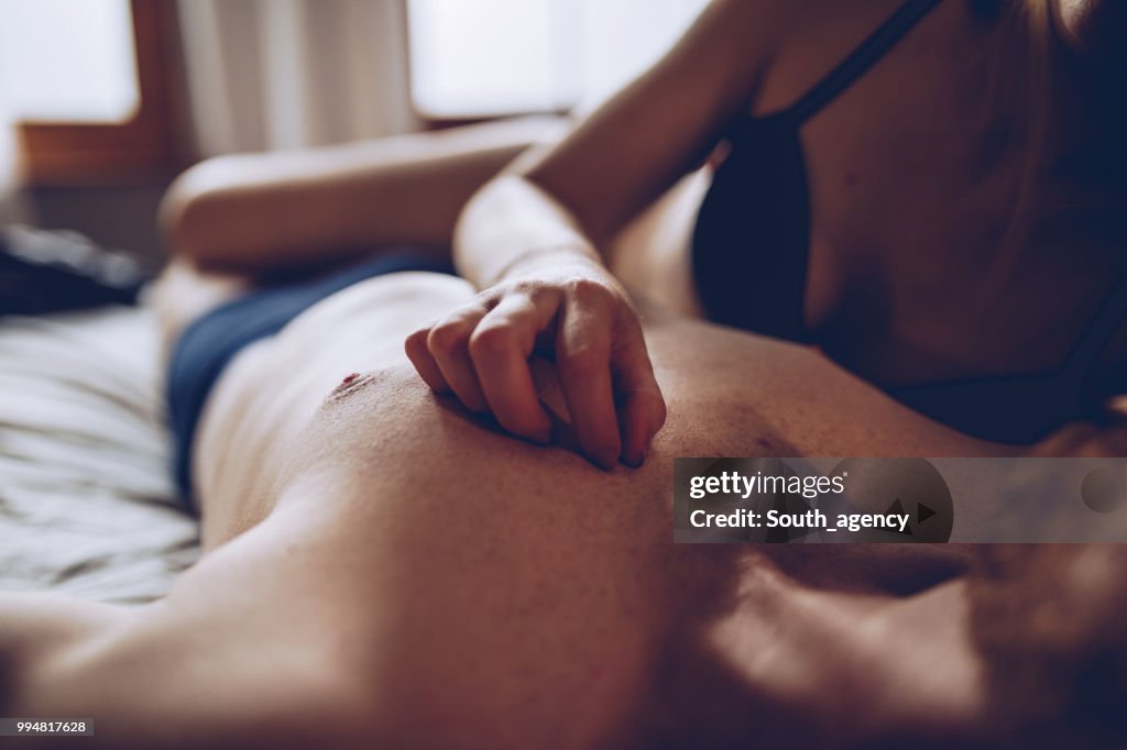 Couple cuddling in the bed