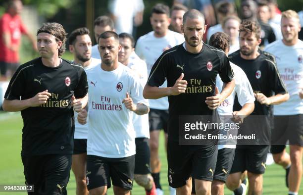 Leonardo Bonucci and Riccardo Montolivo of AC Milan train with theirs teammates during the AC Milan training session at the club's training ground...