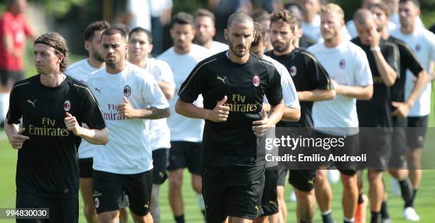 Leonardo Bonucci and Riccardo Montolivo of AC Milan train with theirs teammates during the AC Milan training session at the club's training ground...