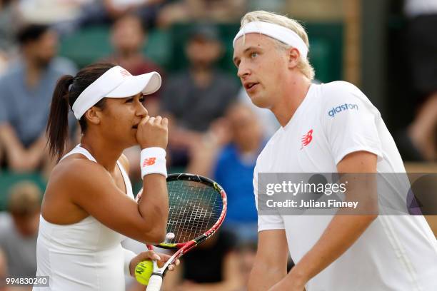 Henri Kontinen of Finland and Heather Watson of Great Britain talk tactics during their Mixed Doubles second round match against Marcin Matkowski of...