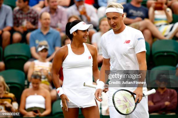 Henri Kontinen of Finland and Heather Watson of Great Britain talk tactics during their Mixed Doubles second round match against Marcin Matkowski of...