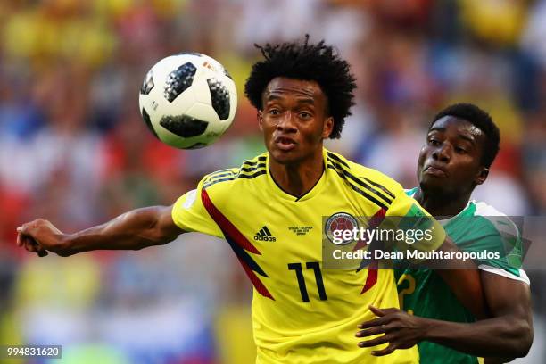 Juan Cuadrado of Colombia is challenged by Moussa Wague of Senegal during the 2018 FIFA World Cup Russia group H match between Senegal and Colombia...