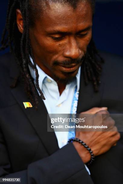 Manager / Head Coach of Senegal, Aliou Cisse puts his hand to his heart after the national anthem prior to the 2018 FIFA World Cup Russia group H...