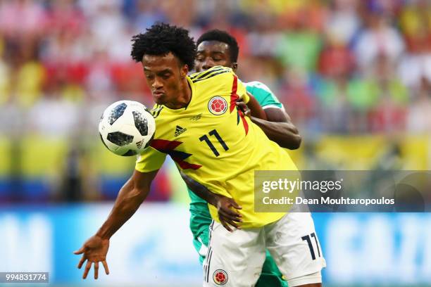 Juan Cuadrado of Colombia is challenged by Moussa Wague of Senegal during the 2018 FIFA World Cup Russia group H match between Senegal and Colombia...