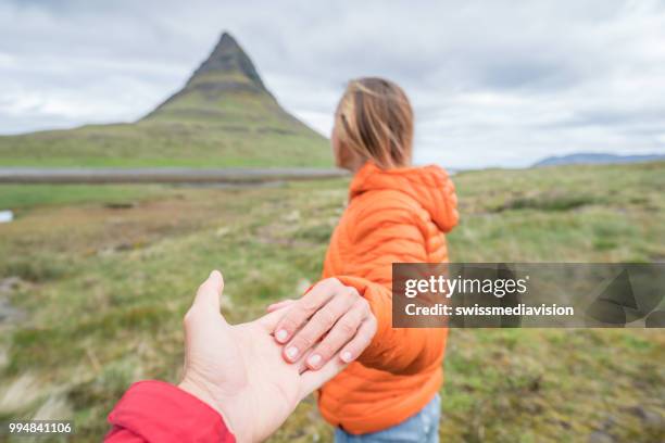 follow me to nature, girlfriend leading man to kirkjufell mountain - follow me stock pictures, royalty-free photos & images